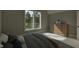 Relaxing bedroom featuring a large window with wooded views and a dresser with modern hardware at 725 Catawba St, Raleigh, NC 27609
