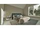 Comfortable bedroom featuring plush bedding, decorative pillows, and a view of the trees at 725 Catawba St, Raleigh, NC 27609