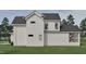 This house boasts a white exterior with a brick foundation and lush green grass surrounding it at 725 Catawba St, Raleigh, NC 27609