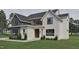 Charming white brick exterior with black trim windows and manicured lawn, enhancing curb appeal and showcasing modern design at 725 Catawba St, Raleigh, NC 27609