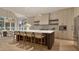 Bright, modern kitchen with large island, bar seating, and open layout to the dining area with natural light at 725 Catawba St, Raleigh, NC 27609