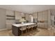 Elegant kitchen with white countertop, wooden cabinets, stainless steel appliances and large island with bar stools at 725 Catawba St, Raleigh, NC 27609