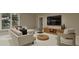 A bright living room is decorated with modern furniture, wooden accents, and large windows at 725 Catawba St, Raleigh, NC 27609