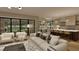 Open-concept living room that seamlessly flows into a dining and kitchen area, with abundant natural light at 725 Catawba St, Raleigh, NC 27609