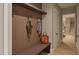 Stylish mudroom with wood paneled walls, bench, coat hooks, and storage shelf at 725 Catawba St, Raleigh, NC 27609