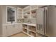 Pantry with stainless steel refrigerator, white cabinets, granite countertops, and woven basket storage at 725 Catawba St, Raleigh, NC 27609