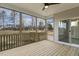 Large screened porch has wood decking, ceiling fan, views of yard and an exterior door at 73 Jumper St, Wendell, NC 27591