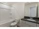 A bathroom with a shower and tub combination and a vanity with granite countertop at 73 Jumper St, Wendell, NC 27591