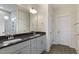 Bathroom with double sink vanity, modern fixtures, and a marble tile shower at 73 Jumper St, Wendell, NC 27591