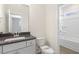 Clean bathroom with grey vanity and white tub at 73 Jumper St, Wendell, NC 27591