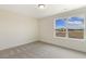 A bedroom with carpet flooring, white walls, and a large window with natural light at 73 Jumper St, Wendell, NC 27591