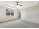 Spacious bedroom with plush carpeting, a tray ceiling, and access to the backyard at 73 Jumper St, Wendell, NC 27591