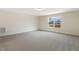 A bedroom with carpet flooring, white walls, and a large window with natural light at 73 Jumper St, Wendell, NC 27591