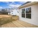 A wooden deck with a railing and a view of the backyard and a neighbor's house at 73 Jumper St, Wendell, NC 27591