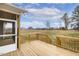 Relaxing screened porch with wooden decking, offering a serene outdoor retreat with views of the expansive backyard at 73 Jumper St, Wendell, NC 27591