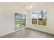 Eat in area with a sliding door to porch, hardwood floors, neutral paint and modern lighting fixture at 73 Jumper St, Wendell, NC 27591