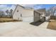 Attached garage with large driveway and landscaping at 73 Jumper St, Wendell, NC 27591