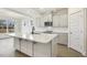Modern kitchen featuring white cabinets, stainless steel appliances, and a spacious center island at 73 Jumper St, Wendell, NC 27591