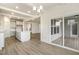Eat in area has view to a modern kitchen with white cabinets and an exterior door to back porch at 73 Jumper St, Wendell, NC 27591