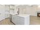 Spacious kitchen island with sink, white countertops, stainless dishwasher and view to Gathering room at 73 Jumper St, Wendell, NC 27591