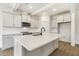 Bright kitchen featuring a large island, modern white cabinets, stainless appliances and stylish backsplash at 73 Jumper St, Wendell, NC 27591