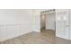 Bright living room with paneled accent wall, hardwood floors and glass paneled french doors at 73 Jumper St, Wendell, NC 27591