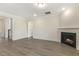 Bright living room with modern fireplace and stylish vinyl flooring at 73 Jumper St, Wendell, NC 27591