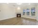 Open concept living area with fireplace and windows overlooking the backyard at 73 Jumper St, Wendell, NC 27591