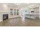 Open concept living space featuring a fireplace, kitchen island, and natural light at 73 Jumper St, Wendell, NC 27591