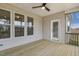 Spacious back porch area featuring a ceiling fan and multiple windows letting in natural light at 73 Jumper St, Wendell, NC 27591