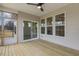Covered porch featuring wood flooring, ceiling fan, and sliding glass door to the backyard at 73 Jumper St, Wendell, NC 27591