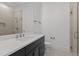 Modern bathroom featuring a sleek vanity with quartz countertop, and a glass-enclosed shower at 30 Chestnut Oak Dr, Youngsville, NC 27596