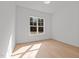 Bright bedroom with a window with nature views and light wood flooring at 30 Chestnut Oak Dr, Youngsville, NC 27596