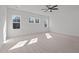 Spacious bedroom featuring carpet floors, ceiling fan, and large windows at 30 Chestnut Oak Dr, Youngsville, NC 27596