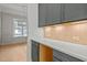 A butler's pantry with gray cabinets and bright counter tops featuring a peek into the dining room at 30 Chestnut Oak Dr, Youngsville, NC 27596