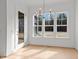Bright dining area with large windows offering scenic outdoor views and a door to a screened porch at 30 Chestnut Oak Dr, Youngsville, NC 27596