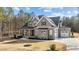 Spacious two-story home featuring gray siding, black roof accents, and a well-manicured front lawn at 30 Chestnut Oak Dr, Youngsville, NC 27596