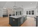 Spacious kitchen island with ample storage, stainless steel appliances, and open layout to the living area at 30 Chestnut Oak Dr, Youngsville, NC 27596