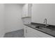Functional laundry room with sleek countertop and cabinet storage space at 30 Chestnut Oak Dr, Youngsville, NC 27596