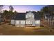 Home exterior at dusk, showing the backyard with a screened in porch at 30 Chestnut Oak Dr, Youngsville, NC 27596