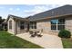 Relaxing backyard showcasing the brick exterior, well-kept lawn, and a cozy patio dining set at 4110 Argyle Trl, Burlington, NC 27215