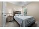 Bedroom with wood headboard, side table, lamp, and natural light from the window at 4110 Argyle Trl, Burlington, NC 27215
