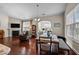 Dining area open to the living room featuring hardwood floors and natural light at 4110 Argyle Trl, Burlington, NC 27215