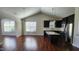 Open-concept living space features dark wood floors, high ceilings, and an island kitchen with stainless steel appliances at 4110 Argyle Trl, Burlington, NC 27215