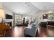 Open-concept living room featuring a fireplace, ceiling fan, and hardwood floors at 4110 Argyle Trl, Burlington, NC 27215