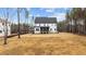 Large backyard view of home with screened-in porch and newly installed lawn at 45 Chestnut Oak Dr, Youngsville, NC 27596