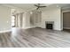 Bright open-concept living room with a fireplace, built-in shelves, and hardwood style flooring at 1245 Azalea Garden Circle, Raleigh, NC 27603