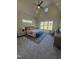 Bright main bedroom featuring vaulted ceilings, a ceiling fan, and large windows overlooking the yard at 1245 Azalea Garden Circle, Raleigh, NC 27603