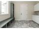 Functional mudroom with tiled floors, built-in bench, cubbies, and storage cabinets at 1245 Azalea Garden Circle, Raleigh, NC 27603