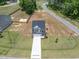 Aerial view of a two story home with a long driveway and large lawn at 22 Van Winkle St, Lillington, NC 27546